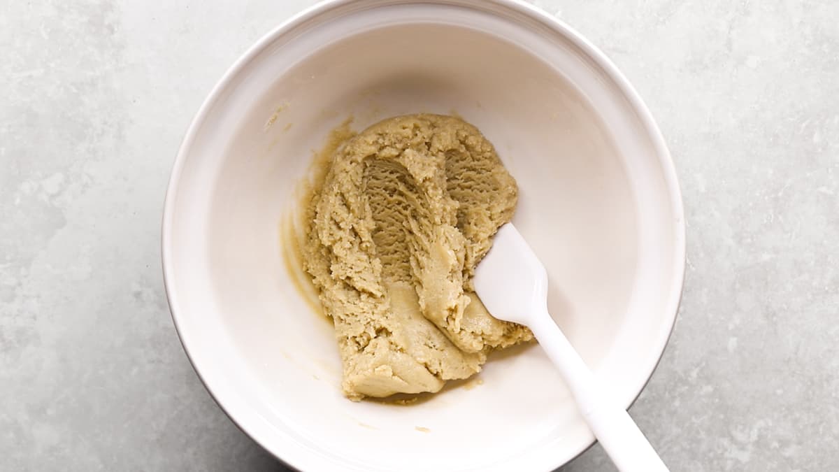 Gluten-free lemon shortbread cookie dough being mixed in a bowl