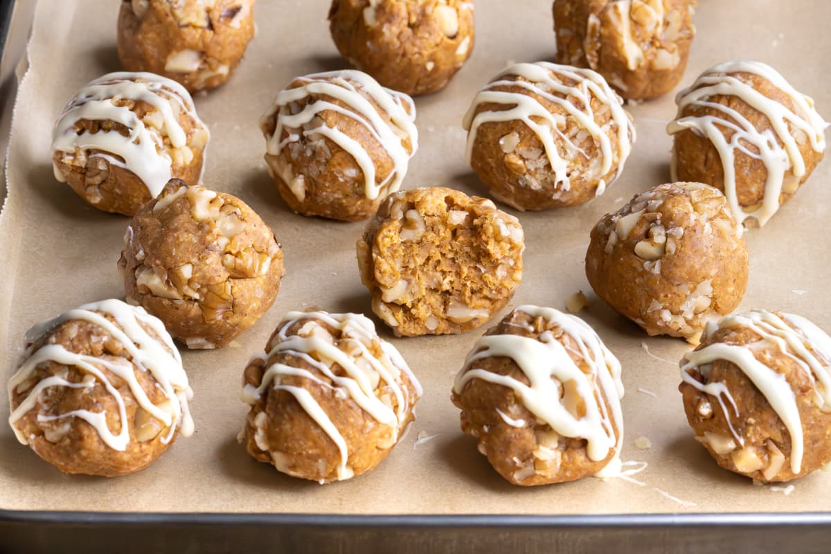 Carrot cake protein balls with a bite taken out of one ball