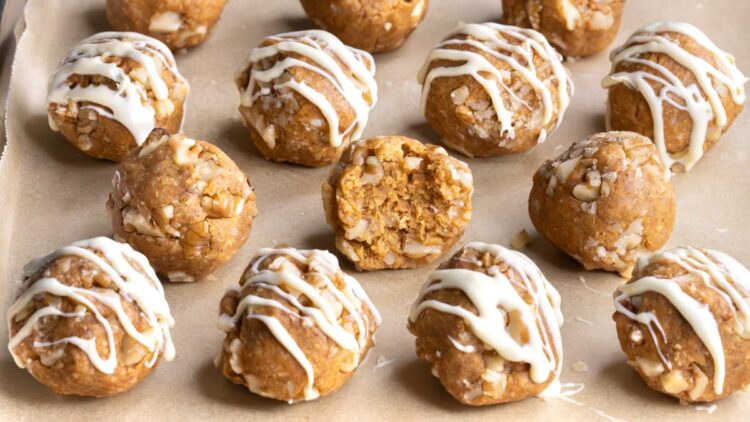 Rows of carrot cake protein balls with white chocolate drizzle