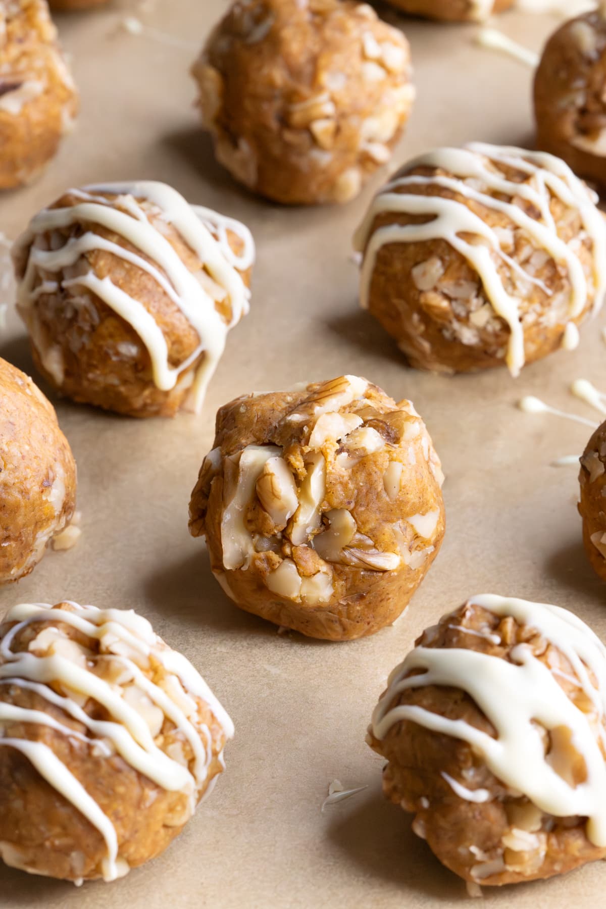 Protein balls coated in chopped walnuts and a drizzle of white chocolate