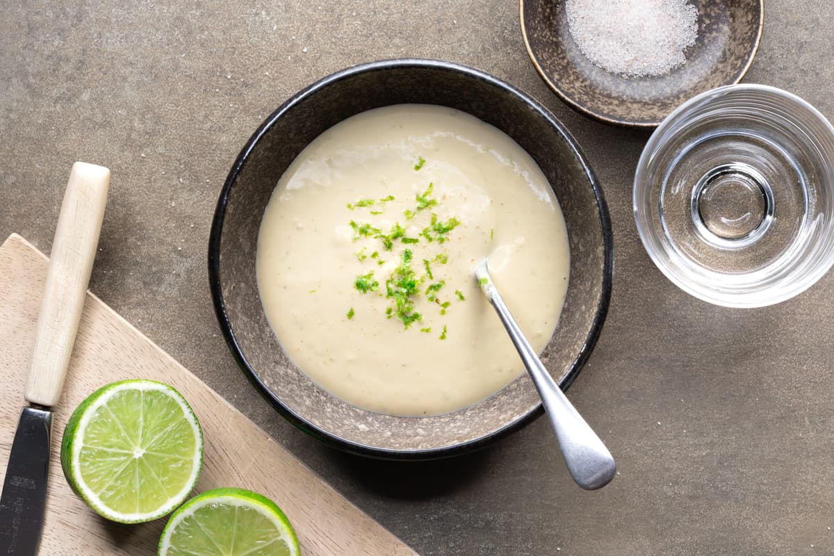 Cashew dressing in a bowl with lime zest garnish