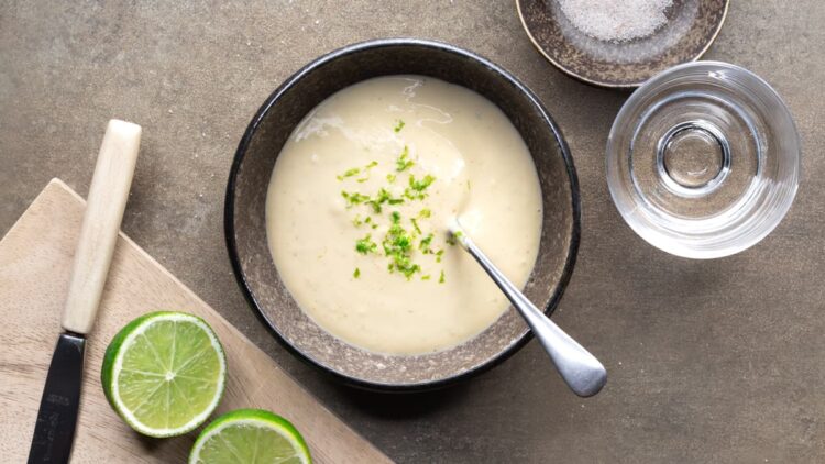 Cashew lime dressing with lime zest stirred together in a bowl