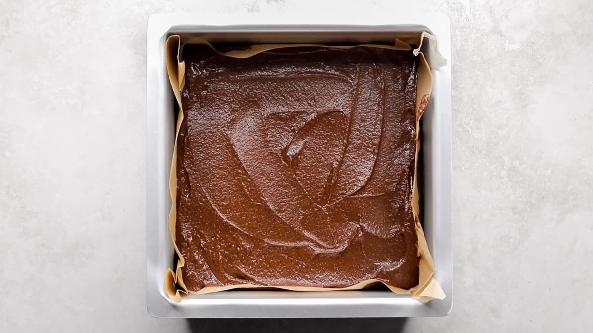 Pour the chickpea chocolate cake batter into the lined cake pan