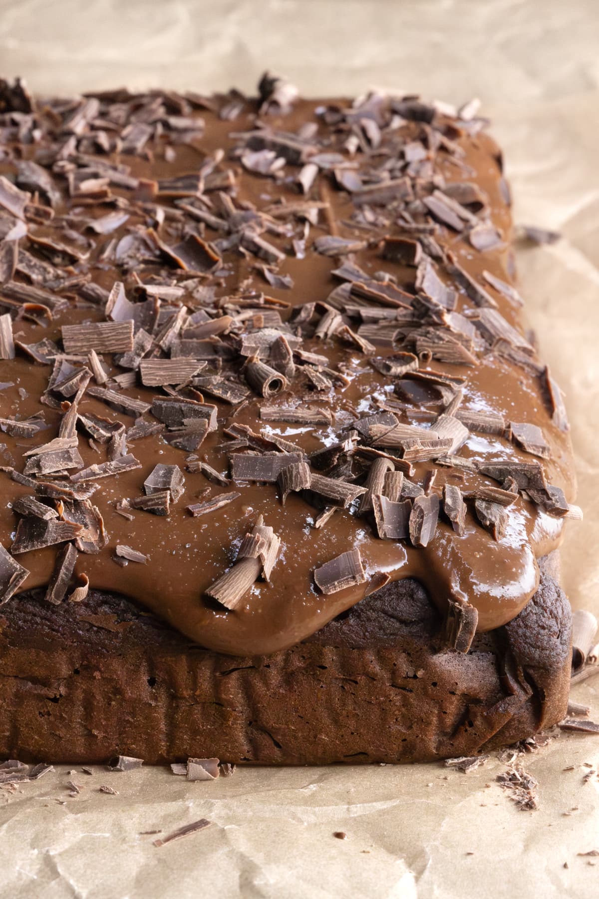 Chickpea chocolate cake topped with frosting and shaved chocolate