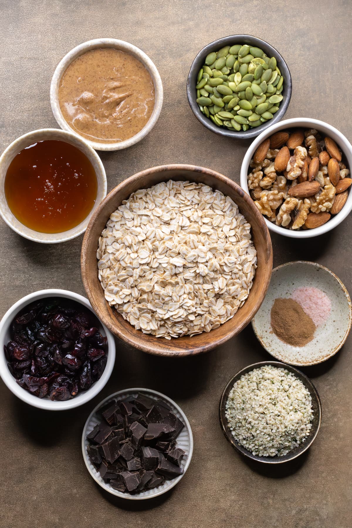 Ingredients for chewy no-bake granola bars set out in bowls