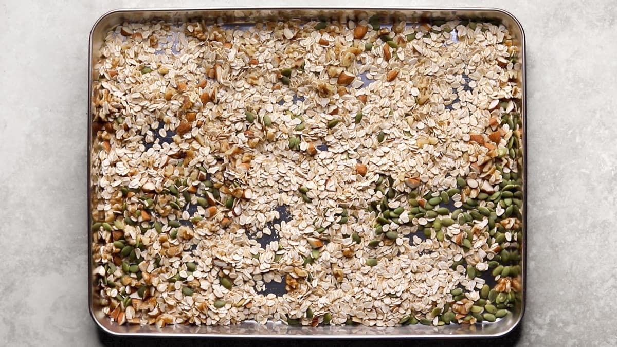 Lightly toast the rolled oats, nuts, and pepitas