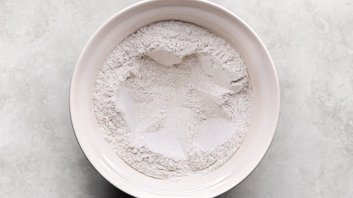 Gluten-free dry ingredients mixed in a large bowl with a well in the center