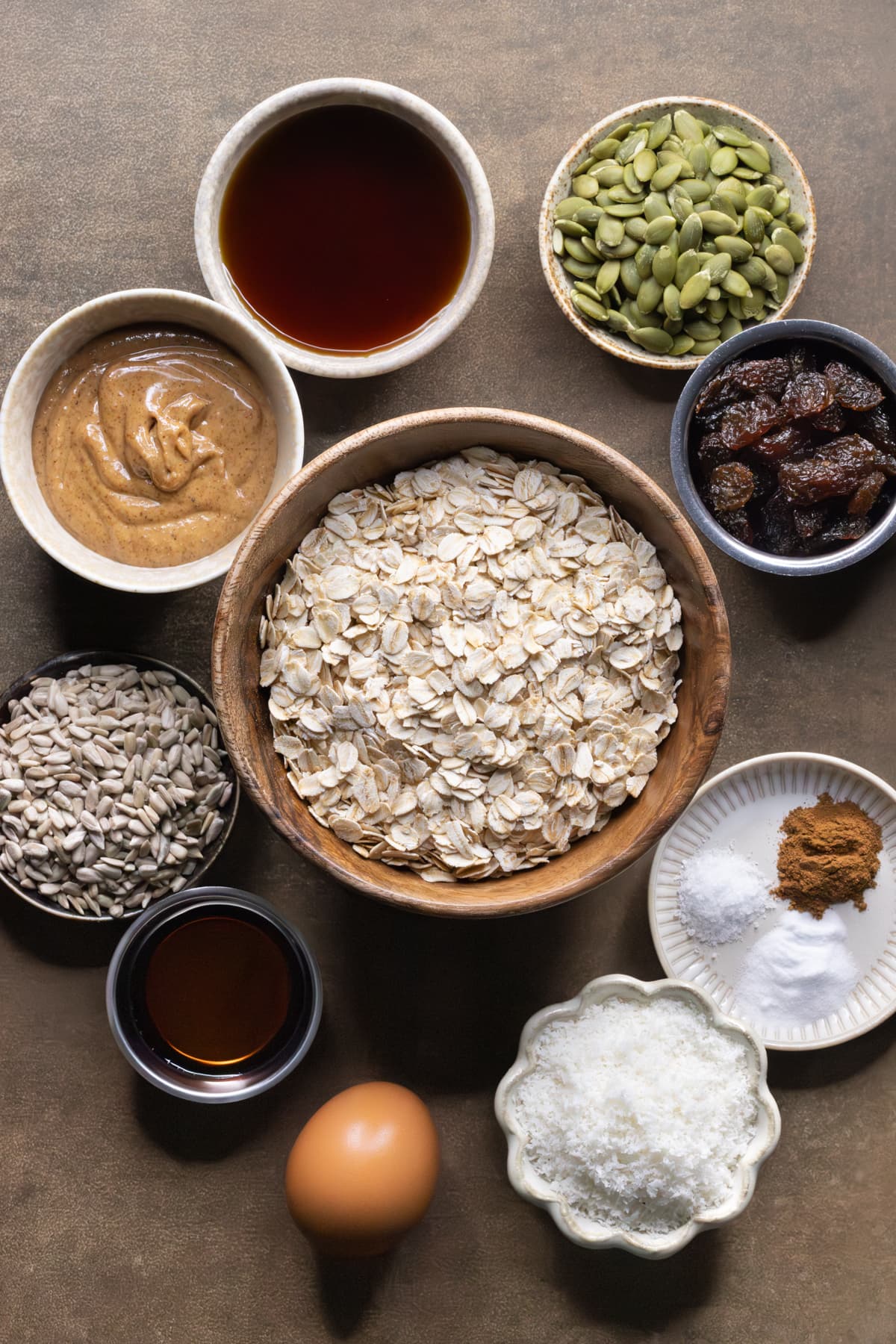Ingredients for oatmeal raisin cookies without flour set out in bowls