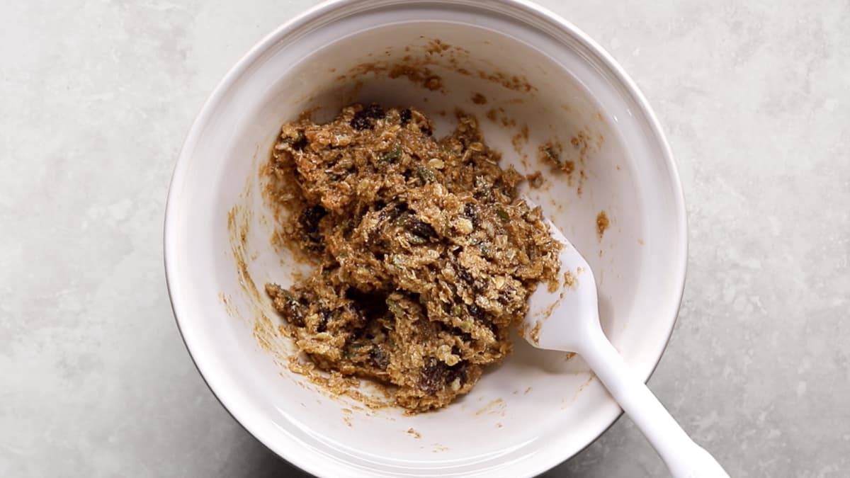 Oatmeal raisin cookie dough fully mixed in a bowl with visible raisins