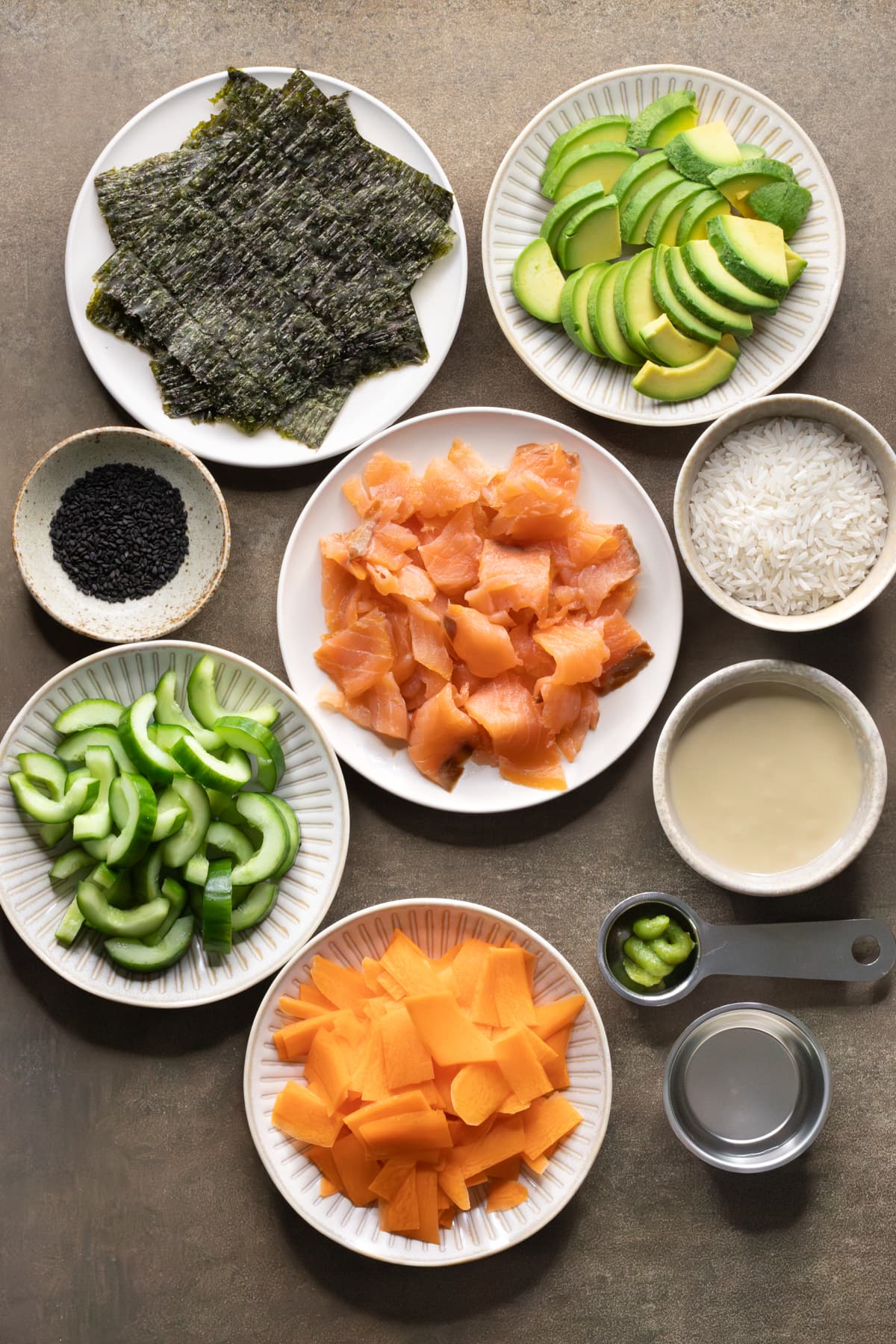 Ingredients for smoked salmon rice bowls set out on plates and in bowls
