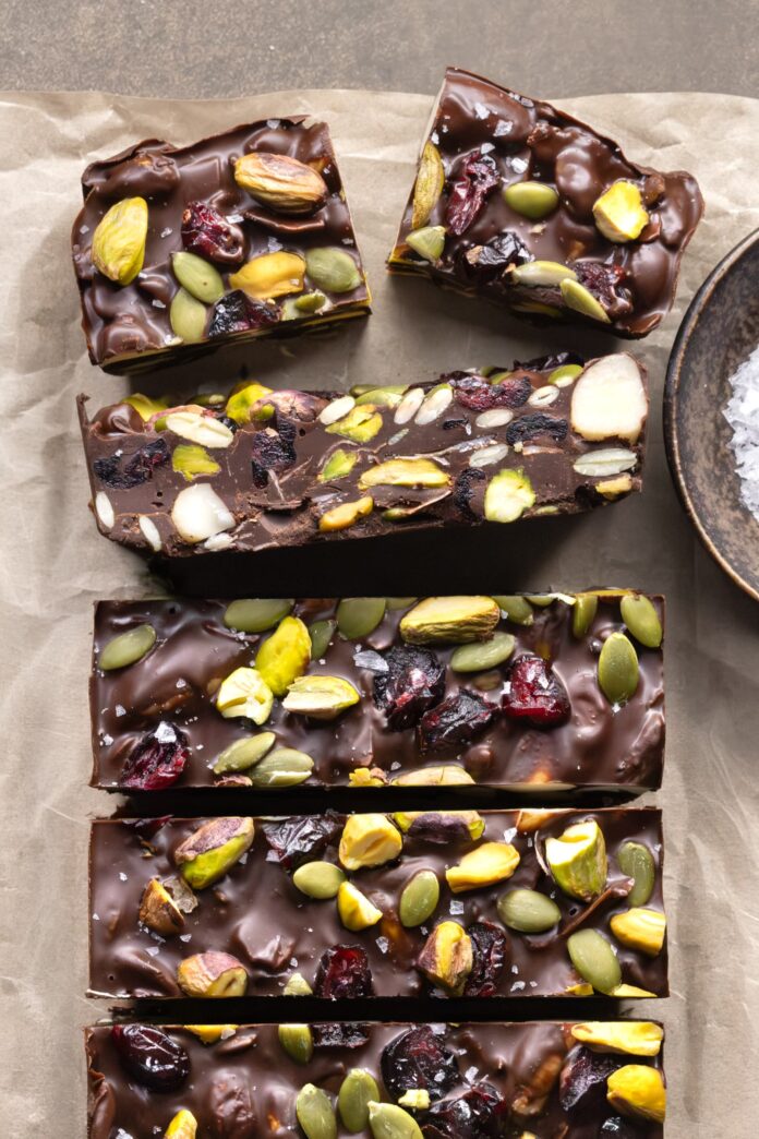 Dark chocolate rocky road bars cut to show nuts, dried fruit, and coconut inside