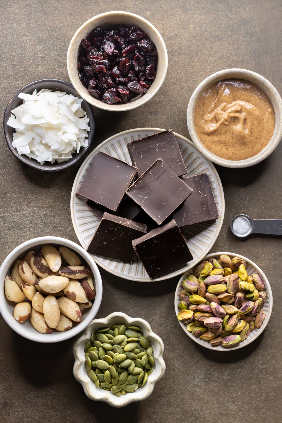 Ingredients for dark chocolate rocky road laid out on plates and in bowls