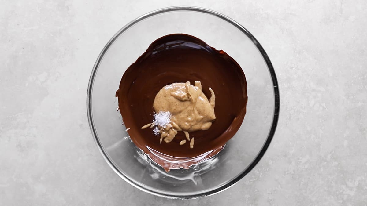 Melted dark chocolate, almond butter, and salt in a mixing bowl