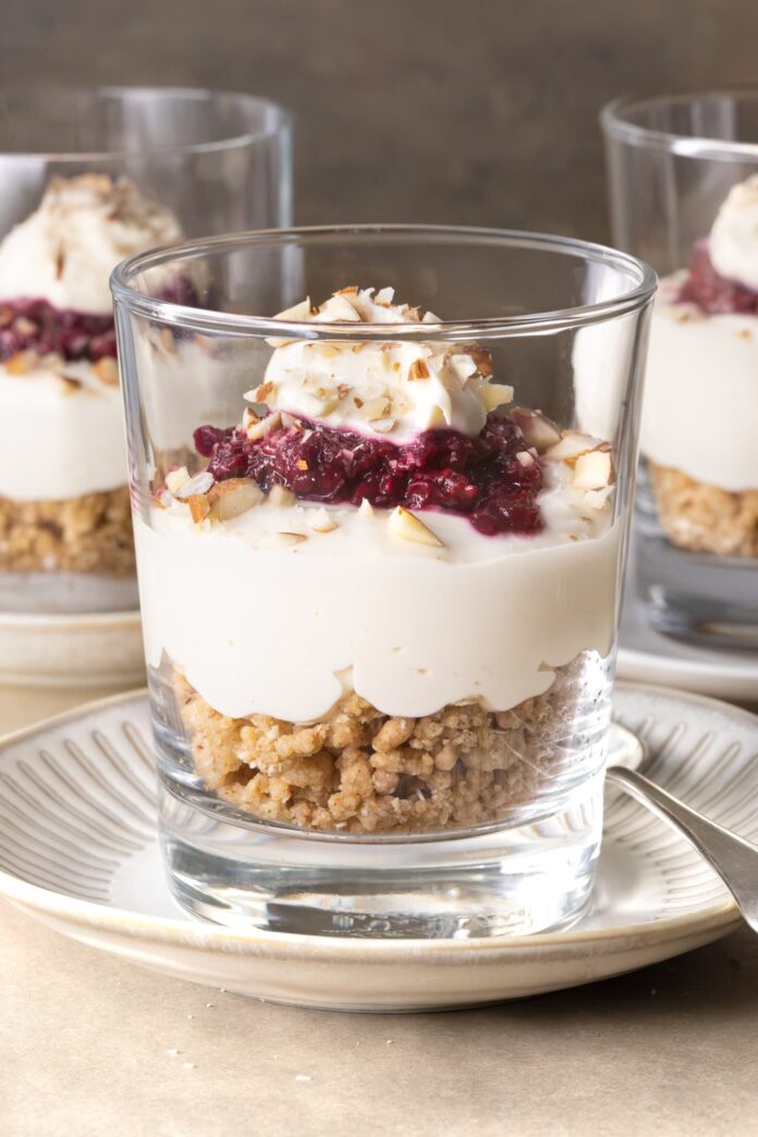 No-bake cheesecake cups with berry compote served in glasses