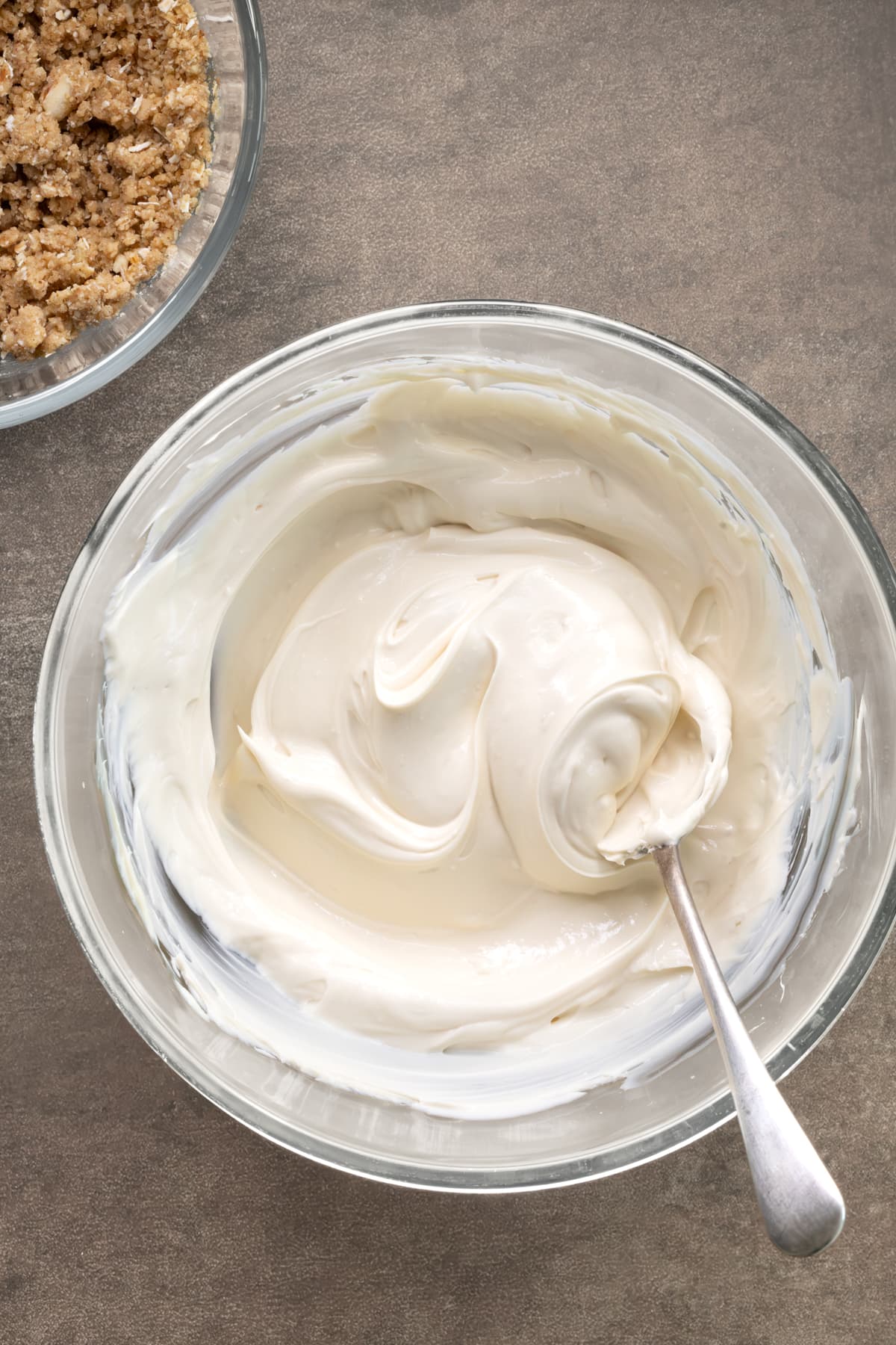 No-bake cheesecake filling in a bowl with a spoon