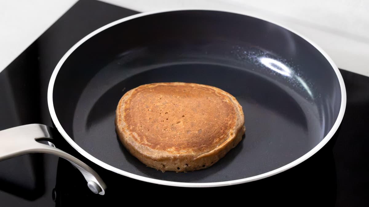 A cooked banana cottage cheese pancake in a frying pan