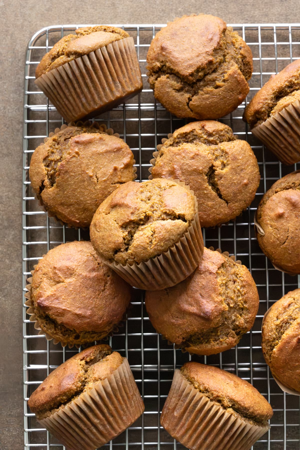 Pumpkin oat muffins arranged on a cooling rack