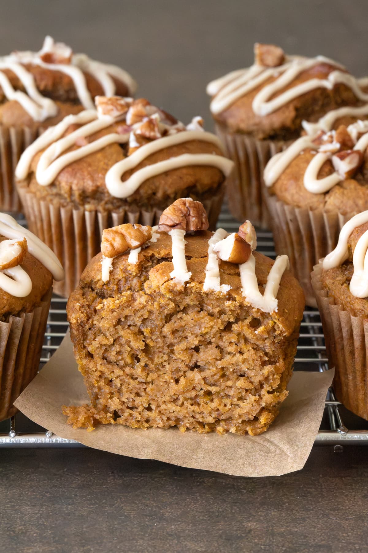 A pumpkin muffin cut in half to show its soft texture